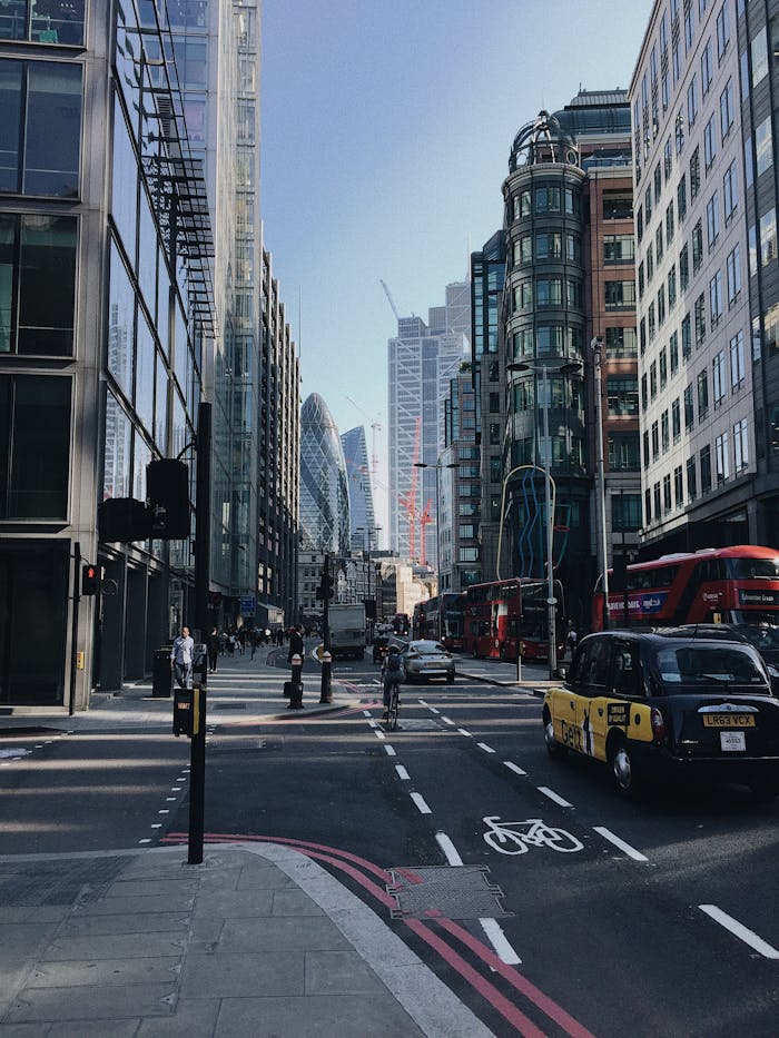 Photo of Cars on Road Near Buildings